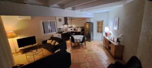 a living room with a couch and a table and a kitchen at Gite le nid du canal in La Celle-sous-Gouzon