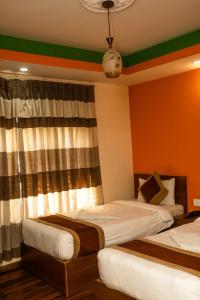 Letto o letti in una camera di Kathmandu Peace Hotel