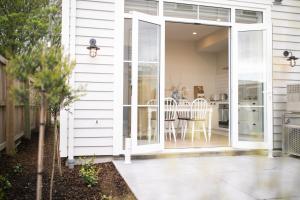 a sliding glass door leading to a patio with a table at 3 Bed Family Retreat Classic Charm With Park Views in Christchurch