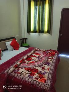 a bedroom with a bed with a blanket on it at Hotel Food Mania in Ner Chowk
