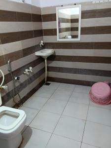 a bathroom with a toilet and a sink at Van Vagdo Prakruti Nivas in Sāsan Gīr