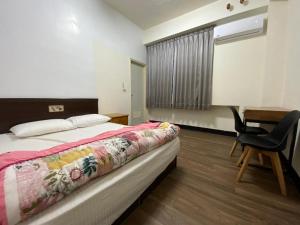 Ένα ή περισσότερα κρεβάτια σε δωμάτιο στο Xiao Gu Homestay
