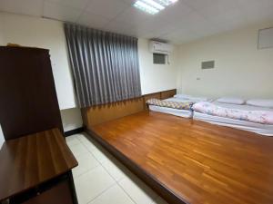 Ένα ή περισσότερα κρεβάτια σε δωμάτιο στο Xiao Gu Homestay