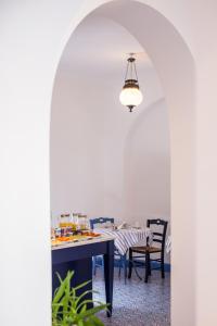 a dining room with a table and a chandelier at Hotel Mignon Meublè in Sorrento