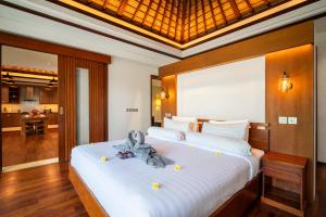 a bedroom with a bed with a towel on it at Bali - Jimbaran Beach Villa Private Pool in Jimbaran +23 photos