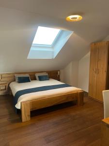 a bedroom with a large bed with a skylight at Restaurant Hammer Highway-Grill in Lucerne