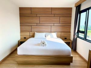 Postel nebo postele na pokoji v ubytování เวลโกรว์ โฮเทล - Wellgrow Hotel
