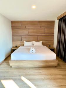 Postel nebo postele na pokoji v ubytování เวลโกรว์ โฮเทล - Wellgrow Hotel