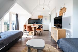 TV a/nebo společenská místnost v ubytování Duinhotel Haga
