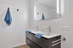 a bathroom with a sink and a mirror at Uithaven 1B Kamperland, view of harbour in Kamperland