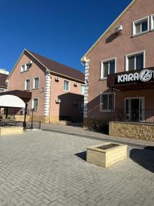 a large brick building with a karma sign on it at SAMAL Hotel in Aksay
