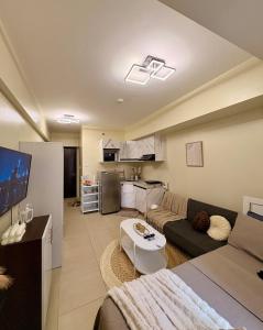 a living room with a couch and a table at Pool view Studio with WiFi & Netflix , Avida Riala in Cebu City