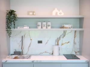 a kitchen with a marble counter top and shelves at Beachside Residence in Koh Samui  +119 photos