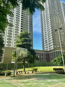 a basketball hoop in front of two tall buildings at Pool view Studio with WiFi & Netflix , Avida Riala in Cebu City