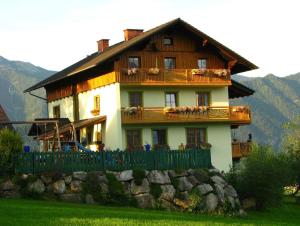 a large house with a fence in front of it at Familienbauernhof Christa in Rossleithen