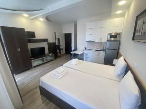 a small room with two beds and a kitchen at Apartment In Batumi MGZAVREBI in Batumi