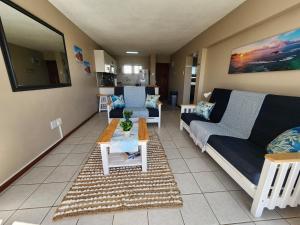 a living room with a couch and a table at Beautiful Sea view apartment 45 De Valle Diaz Mosselbay in Mossel Bay
