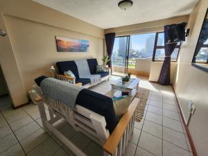 a living room with a couch and a table at Beautiful Sea view apartment 45 De Valle Diaz Mosselbay in Mossel Bay