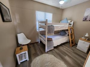 a small room with two bunk beds and a rug at Beautiful Sea view apartment 45 De Valle Diaz Mosselbay in Mossel Bay +43 photos