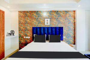 Voodi või voodid majutusasutuse Super Townhouse Mysore Central toas