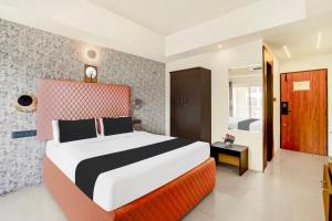 Voodi või voodid majutusasutuse Super Townhouse Mysore Central toas