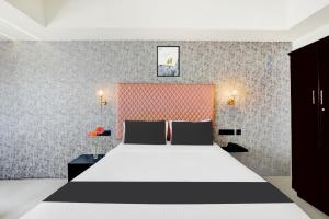 Voodi või voodid majutusasutuse Super Townhouse Mysore Central toas