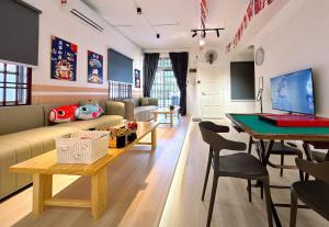a living room with a couch and a table at BBQ Swimming Pool Netflix 11 Pax Bukit Indah JB in Johor Bahru
