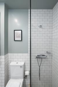 a white bathroom with a toilet and a shower at Trikoupi 95 in Athens +117 photos