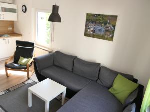 a living room with a gray couch and a chair at Haus Budinger in Alf