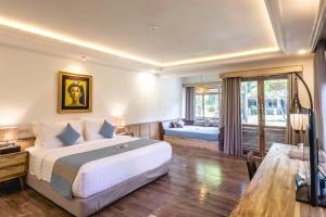 a bedroom with a large bed and a living room at Vila Ombak in Gili Trawangan +121 photos