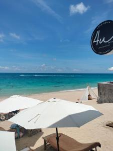 two umbrellas and chairs on a beach with the ocean at 4U Resort Samui in Lamai