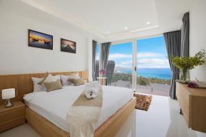 a bedroom with a white cat laying on a bed at Villa The Wave in Chaweng Noi Beach +290 photos