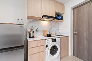 a kitchen with a washing machine and a refrigerator at Brand New Condo Near Lamai Beach - B411 in Lamai