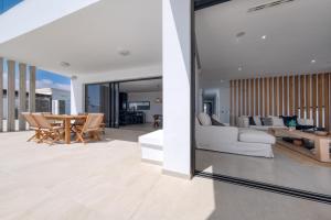 a living room with a couch and a table at White House - Fire pit and Private pool By Lanzarote Vacation Homes in Puerto Calero