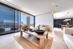 a living room with a couch and a table at White House - Fire pit and Private pool By Lanzarote Vacation Homes in Puerto Calero