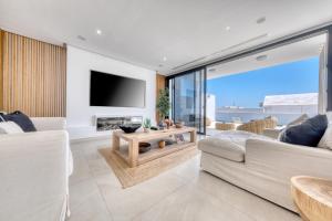 a living room with a couch and a tv at White House - Fire pit and Private pool By Lanzarote Vacation Homes in Puerto Calero +64 photos