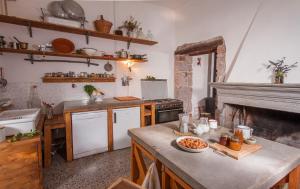 a kitchen with a stove and a table with food on it at Traditional House, view on lake, yoga, sauna R4543 in Sorradile +90 photos