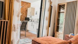 a kitchen with a door open to a living room at Chalet Tikaz Sandjo in Entre-Deux