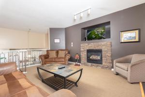 a living room with a couch and a fireplace at Paradise Canyon Golf Resort - Luxury Villa 409 in Lethbridge