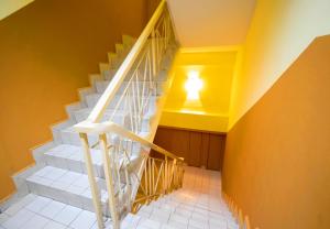 a white staircase with a light on the ceiling at Sun Inns Hotel Sunway Mentari in Petaling Jaya