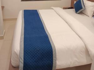 a bed with a blue tie on it at Hotel Garden View - Mansarovar in Jaipur