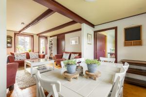 Una sala de estar con una mesa y sillas blancas. en Winsum - Groningen - 6 pers. Cosy Cottage - Op en Bie t Woater, en Winsum