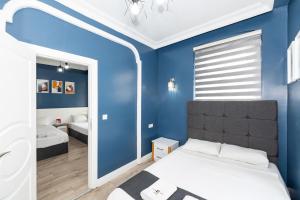 Dormitorio azul con cama y espejo en Butterfly House, en Estambul