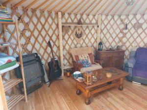 a room with a couch and a table in a yurt at Jurta v Hájích in Oldřichov v Hájích