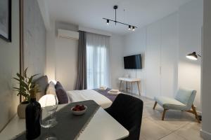 a living room with a bed and a dining room at Trikoupi 95 in Athens