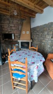 a wooden bed in a room with a stone wall at Las Estrellas de Laguarta in Laguarta +5 photos