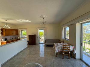 a kitchen and living room with a table and a couch at Santis apartment in Areopolis