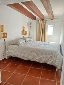 a bedroom with a large bed in a room at La Casa Vertical casco histórico de Segorbe in Segorbe +22 photos