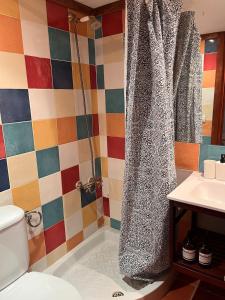 a bathroom with a shower curtain and a sink at La Casita Vertical casco histórico de Segorbe in Segorbe +18 photos