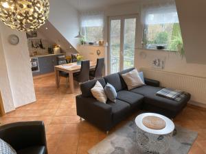 a living room with a couch and a table at Ferienwohnungen Grafenfelder Hof in Gerolstein